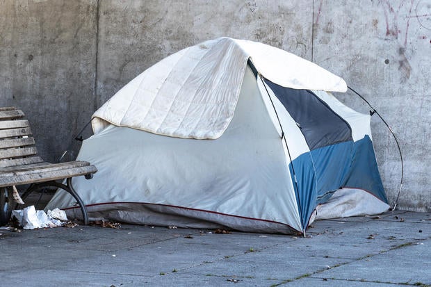 Tent of a homeless person under a bridge in a city 