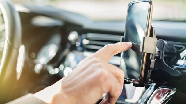 Man using smart phone in car 