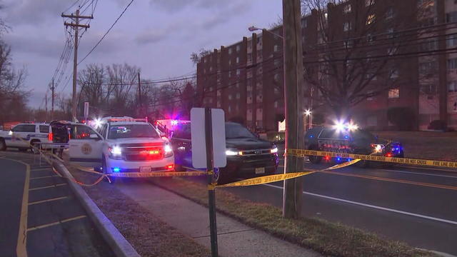 Police tape and emergency vehicles are seen near the apartment building at 860 Lower Ferry Road in Ewing Township 