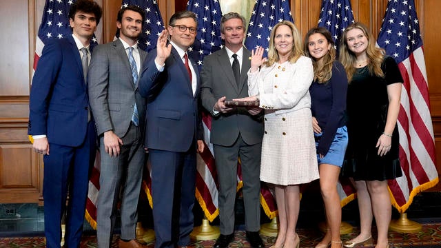 House Speaker Mike Johnson, R-La., third left, poses during a ceremonial swearing-in with Rep. Laura Gillen, D-N.Y., third right, and members of Gillen's family, in the Rayburn Room at the Capitol in Washington, Friday, Jan. 3, 2025. 