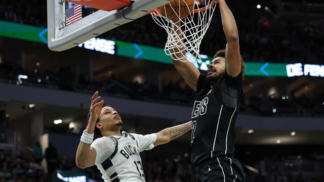 Cameron Johnson #2 of the Brooklyn Nets dunks in front of Ryan Rollins #13 of the Milwaukee Bucks during the second half of a game at Fiserv Forum on January 02, 2025 in Milwaukee, Wisconsin. 