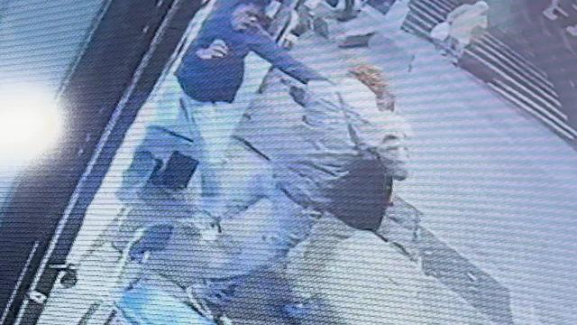 Surveillance video shows a 17-year-old boy, a 22-year-old man and a 62-year-old man in a physical altercation in the doorway of a restaurant. 