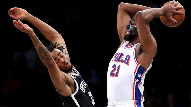 Joel Embiid #21 of the Philadelphia 76ers handles the ball as Nic Claxton #33 of the Brooklyn Nets defends during the first quarter at Barclays Center on January 04, 2025 in the Brooklyn borough of New York City. 