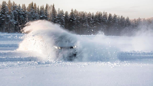 A vehicle sliding into deep snow causing an explosion effect 