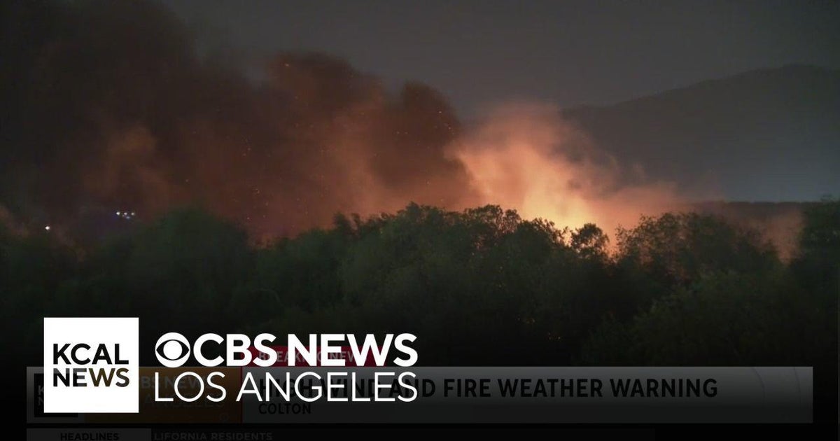 Firefighters work to put out Colton brushfire as winds hit the area ...
