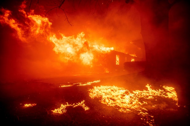 The Eaton Fire destroys a structure in Altadena, California, on Jan. 7, 2025.