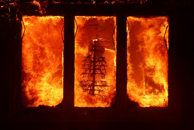 The Palisades Fire burns a Christmas tree inside a residence in the Pacific Palisades neighborhood of Los Angeles, Jan. 7, 2025. 