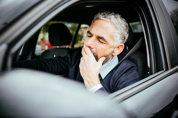 Tired man driving car 