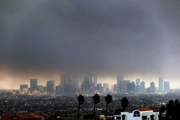 Thick, heavy smoke from wildfires shrouds downtown Los Angeles on Jan. 8, 2025. 