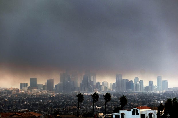 Thick, heavy smoke from wildfires shrouds downtown Los Angeles on Jan. 8, 2025.