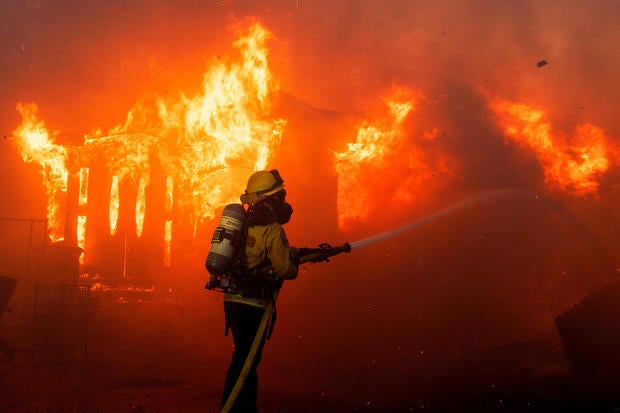 A firefighter battles flames as the Palisades Fire burns on the west side of Los Angeles, California, Jan. 7, 2025. 