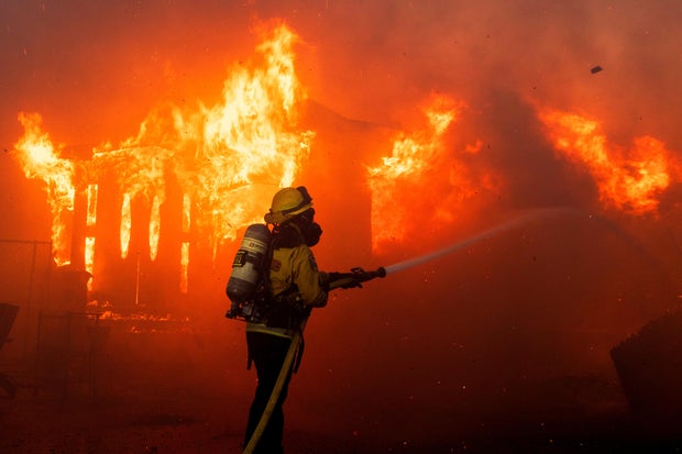 A firefighter battles flames as the Palisades Fire burns on the west side of Los Angeles, California, Jan. 7, 2025.