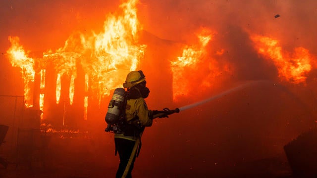 A firefighter battles flames as the Palisades Fire burns on the west side of Los Angeles, California, Jan. 7, 2025. 