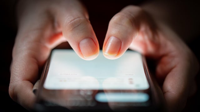 Fingers tapping smartphone screen