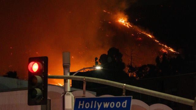 Flames are seen on the hillsides above Hollywood Blvd. during the Sunset Fire 