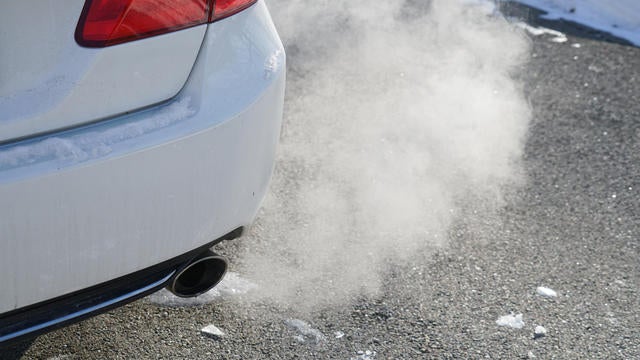 Close up on smoke from car pipe exhaust in winter season 