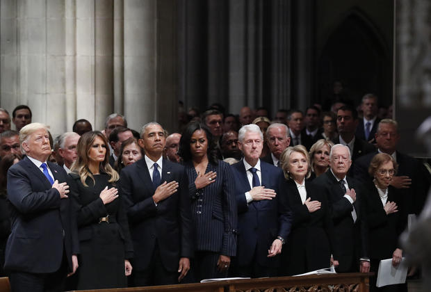 President Donald Trump, First Lady Melania Trump, former President Barack Obama, former First Lady Michelle Obama, former President Bill Clinton, Hillary Clinton, former secretary of state, former President Jimmy Carter, and former First Lady Rosalynn Carter stand during a state funeral service for former President George H.W. Bush at the National Cathedral in Washington, DC, US, on Wednesday, Dec. 5, 2018. 