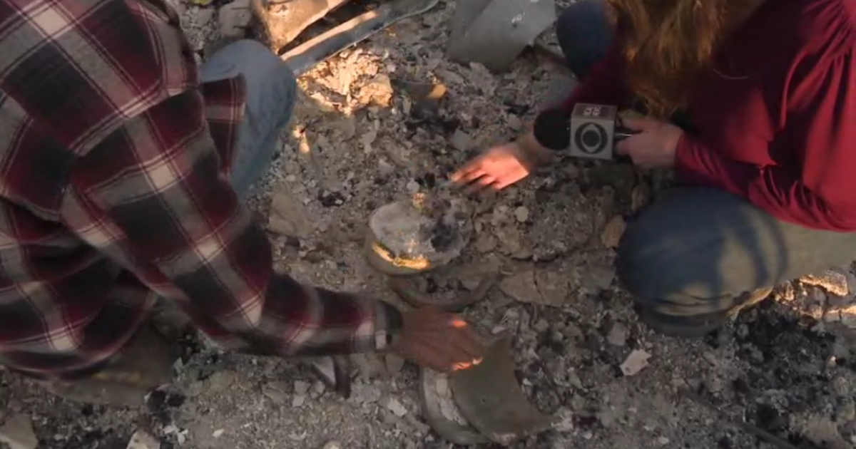 An Altadena man searches the rubble of his burned home and finds an urn containing his deceased wife’s ashes