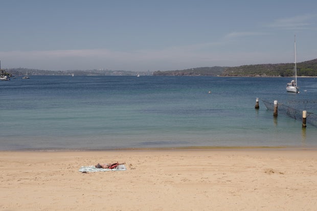 A lone sunbather sits on the beach during the morning sunshine at Manly on Nov. 26, 2024, in Sydney, Australia.