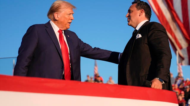 Donald Trump greets opera singer Christopher Macchio at a campaign rally at the Butler Farm Show, Saturday, Oct. 5, 2024, in Butler, Pa. 