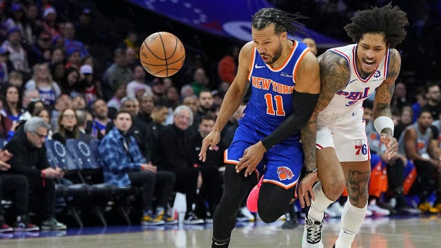 Jalen Brunson #11 of the New York Knicks collides with Kelly Oubre Jr. #9 of the Philadelphia 76ers in the first half at the Wells Fargo Center on January 15, 2025 in Philadelphia, Pennsylvania. 