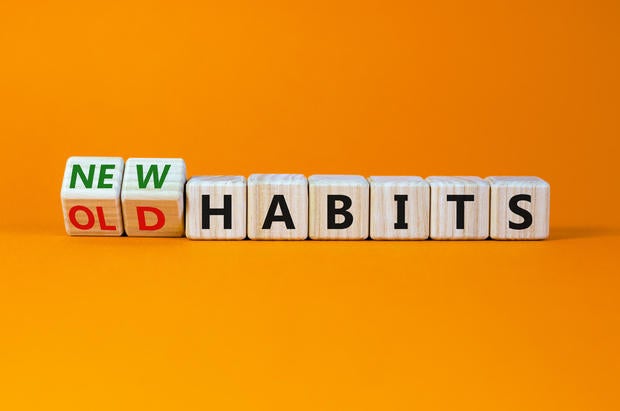 New or old habits symbol. Turned wooden cubes, changed words 'old habits' to 'new habits'. Beautiful orange table, orange background. Business, old or new habits concept. Copy space.