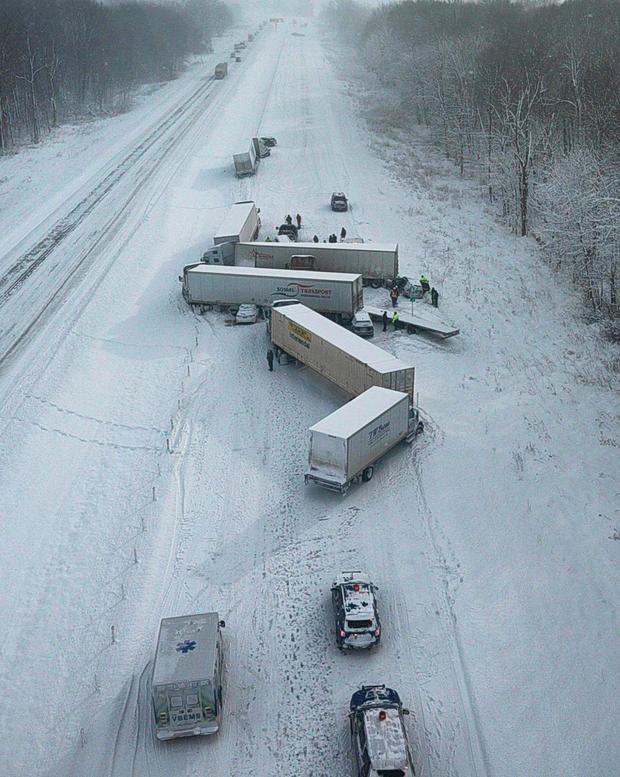 Aerial view of jackknifed semis on an interstate. 