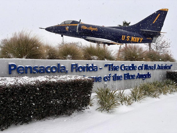 Snow falls around a decommissioned U.S. Navy Blue Angels aerobatics team jet in Pensacola