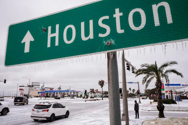 Icicles hang from a sign pointing the way to Houston