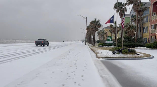 Gulf Coast beaches, houses, and cars are cloaked in snow following a winter storm, in Galveston