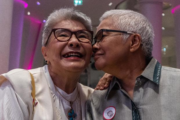 Thai LGBT couple poses for a photo during the registration 