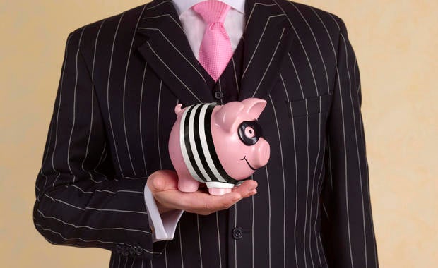 Banker/financial advisor with burglar piggy bank 