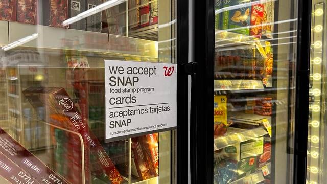 Bilingual sign on door of frozen food aisle, We accept SNAP food stamp cards, Walgreens, Queens, New York 