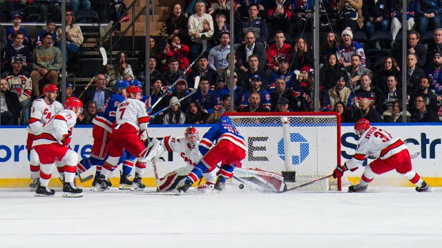 Andrei Svechnikov #37 of the Carolina Hurricanes pokes the puck away from Sam Carrick #39 of the New York Rangers at Madison Square Garden on January 28, 2025 in New York City. 