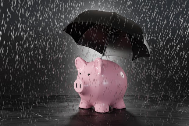 Pink piggy bank holding a black umbrella in heavy rain. Illustration of the concept of protection of savings and investment