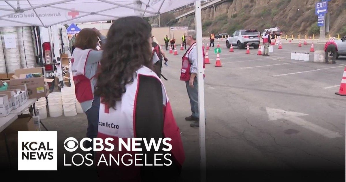 American Red Cross volunteers pass out supplies to wildfire victims ...