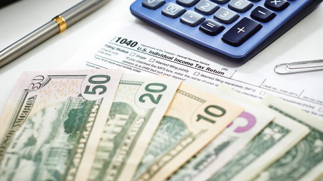 US Currency with calculator and Tax Form 