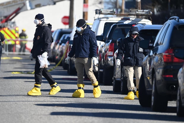 FBI agents collect evidences at the scene of the Philadelphia plane crash 