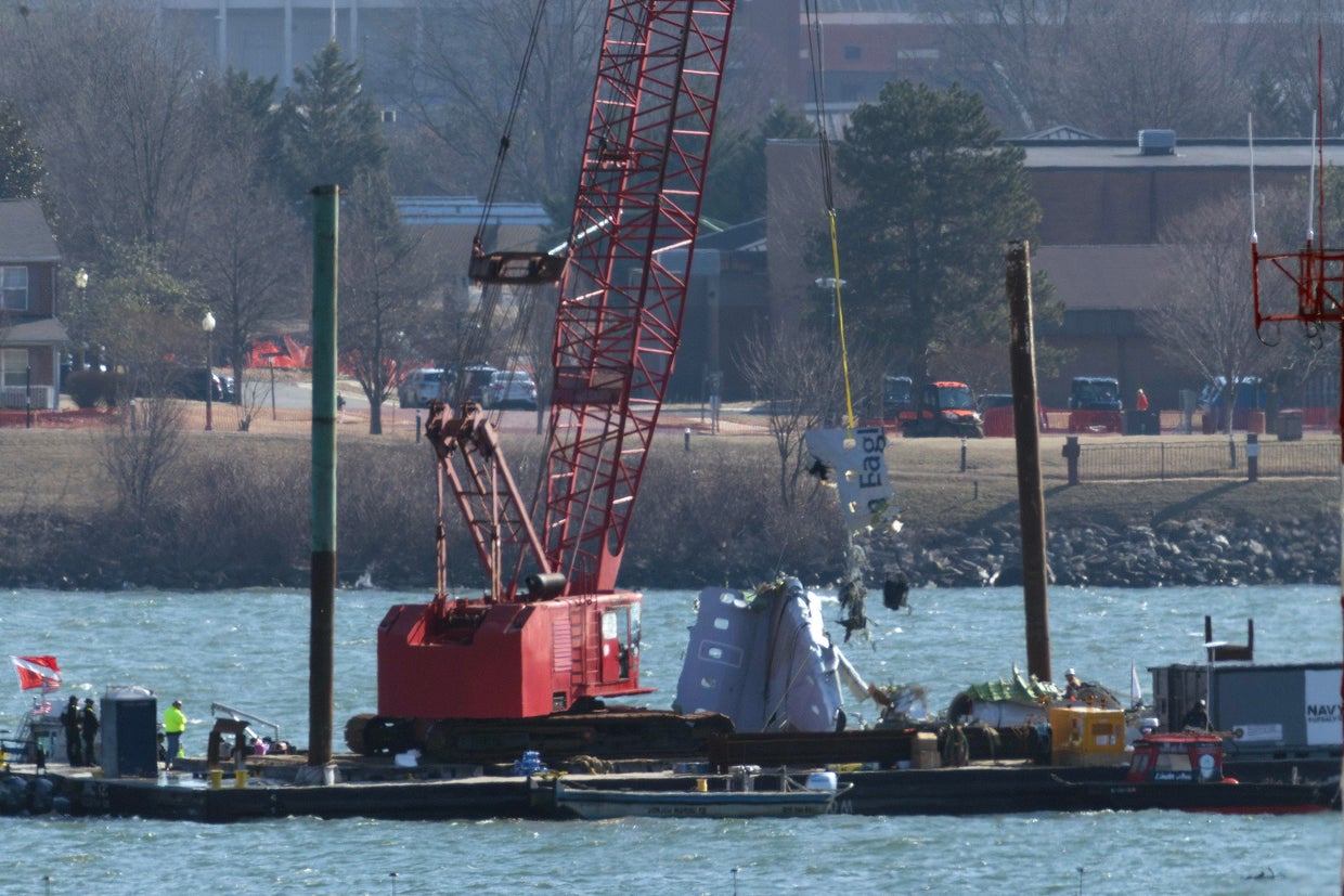 A crane pulls up a portion of an American Airlines regional plane during recovery efforts Feb. 4, 2025, in Arlington, Virginia. 