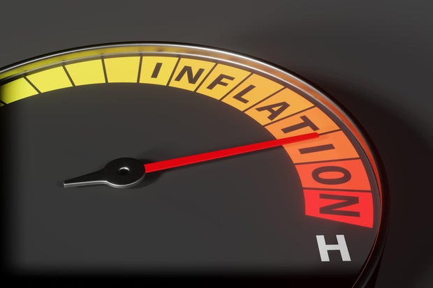 Dashboard oil pressure gauge has a scale showing INFLATION and a needle pointing at the danger red zone. Illustration of the concept of high inflation rate and increasing cost of living 