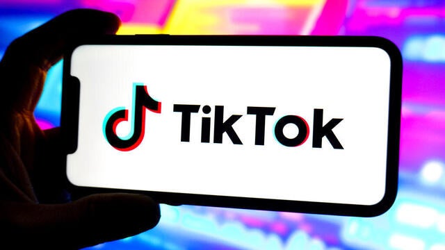 In this photo illustration, a Tik Tok logo is displayed on 