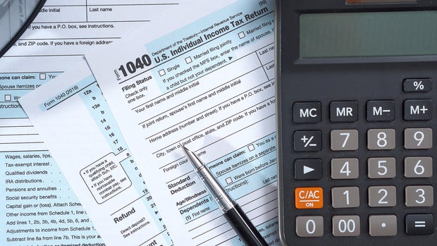 Tax Forms and Calculator on Desk 
