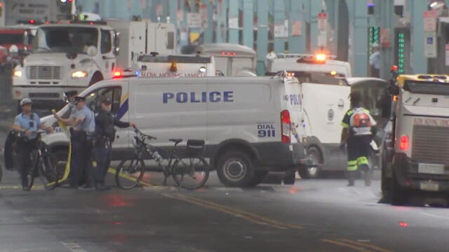 Police officers and vehicles are seen in Kensington 