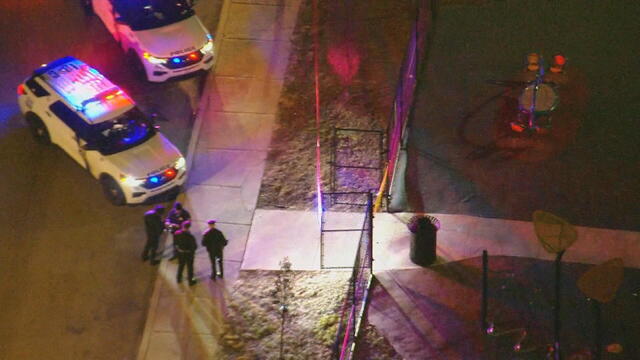 Overhead shot of police cars and tape near a park in Southwest Philadelphia 