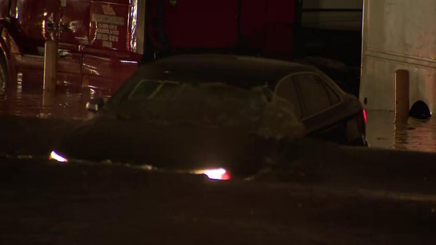 A sedan stuck in floodwaters 