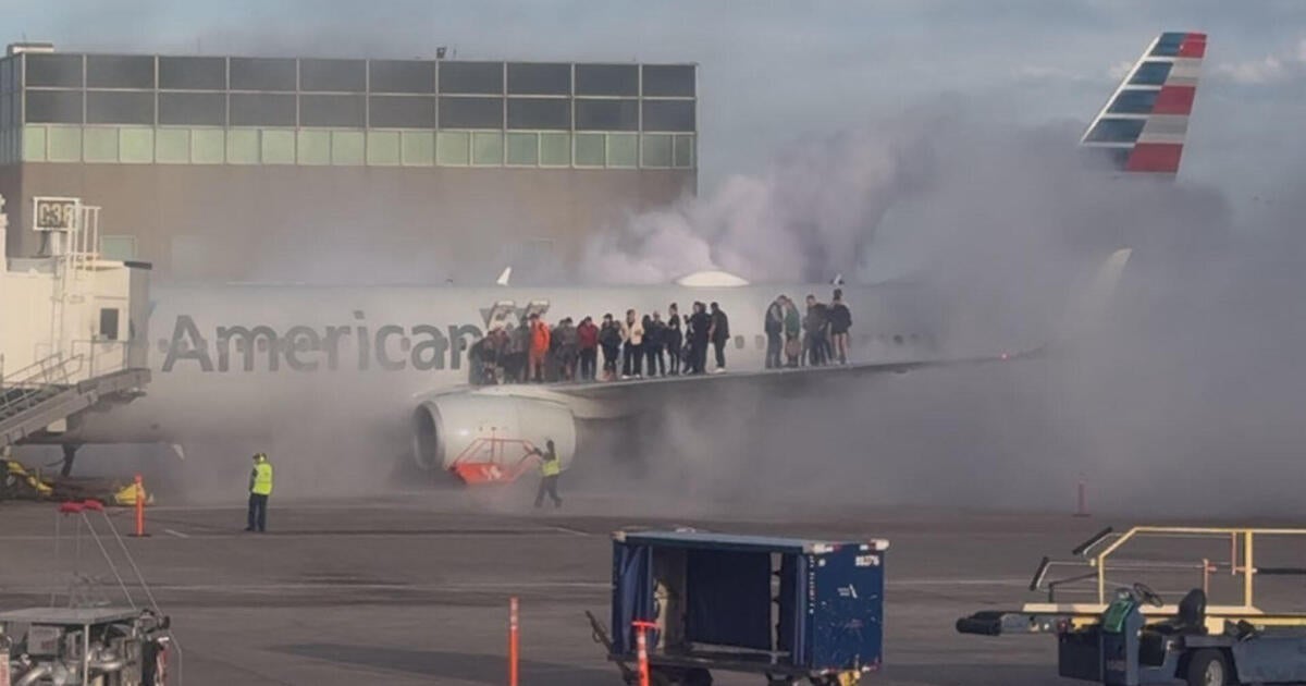 Passengers evacuate after American Airlines plane catches fire at DIA