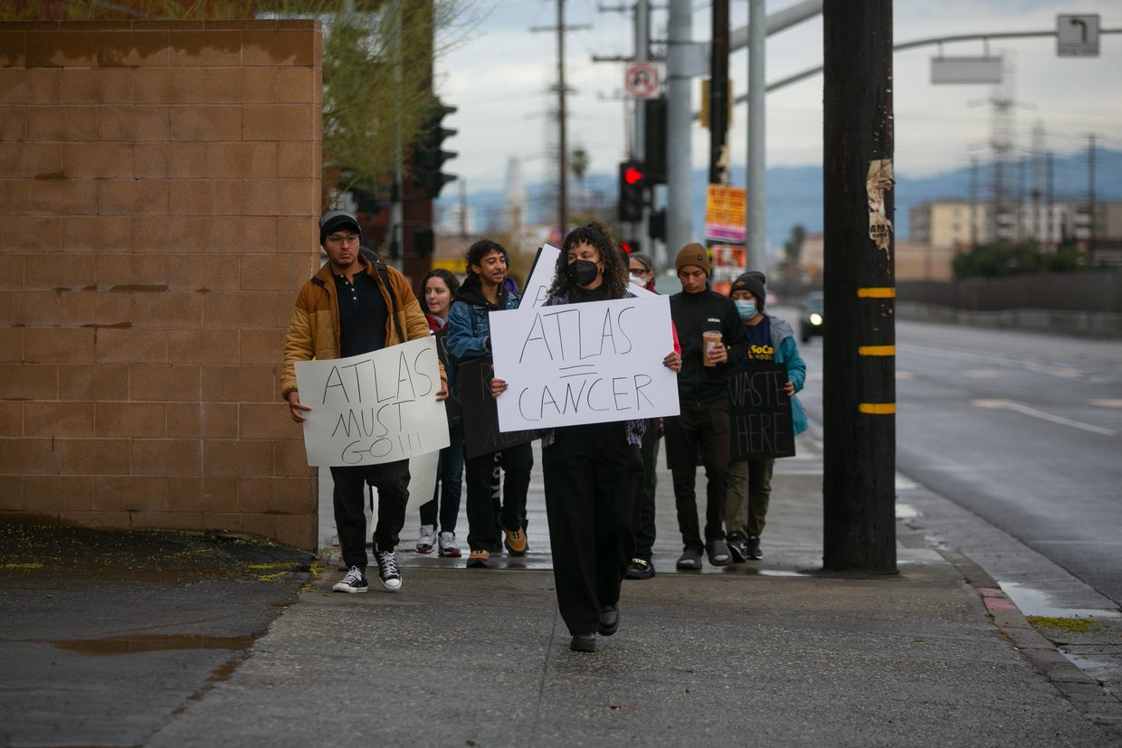 Jordan High School students and community members protest in front of Atlas Iron and Metal Company that is located next door to the school 