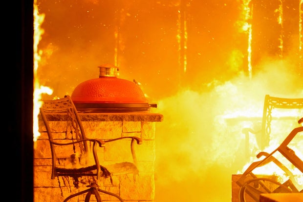 A fire burns a residence during a wildfire outbreak in Stillwater, Oklahoma, March 14, 2025. 