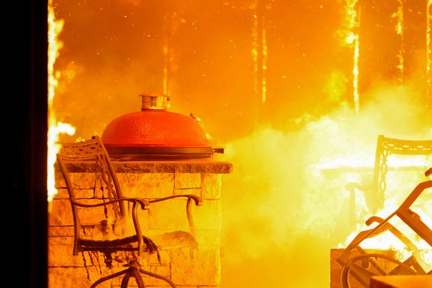 A fire burns a residence during a wildfire outbreak in Stillwater, Oklahoma, March 14, 2025.
