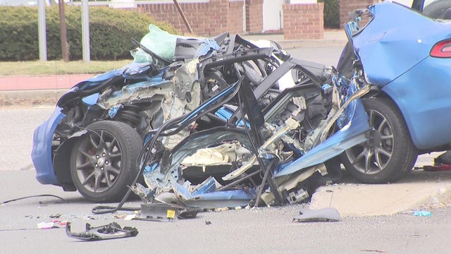 A sedan that has been severely damaged in a crash. 